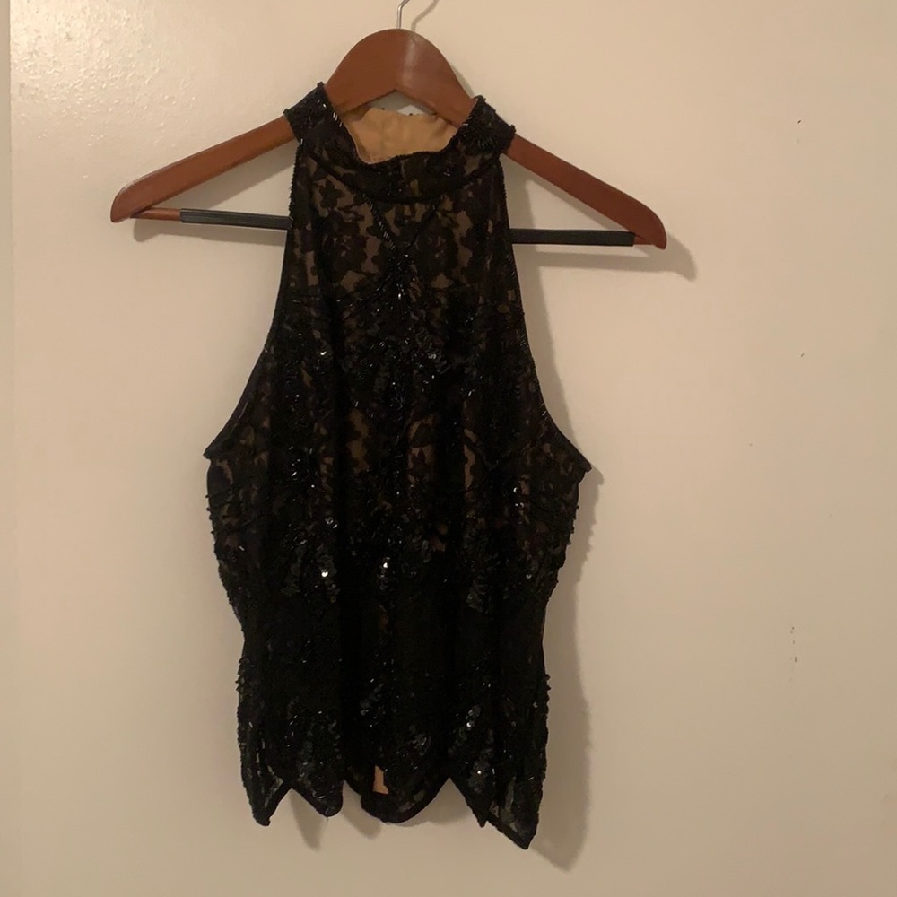 Cashe sleeveless black beaded top.